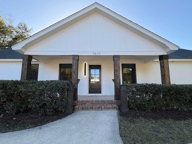 view of exterior entry featuring a porch