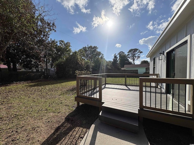 wooden deck with a lawn