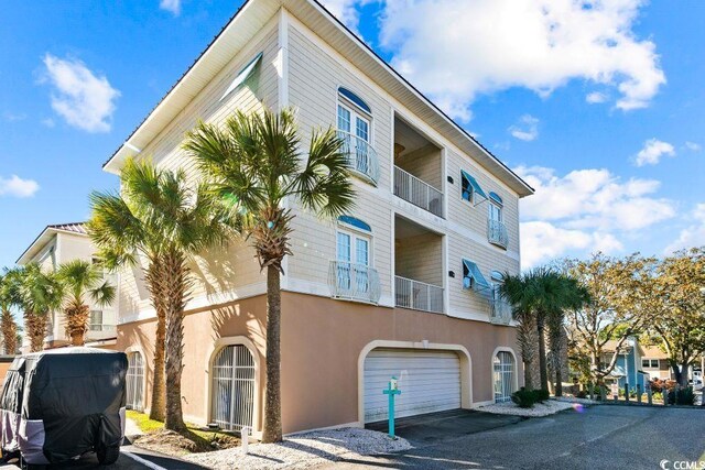 304 76th Ave N Unit D, Myrtle Beach, SC 29572 - view of property with a garage and asphalt driveway