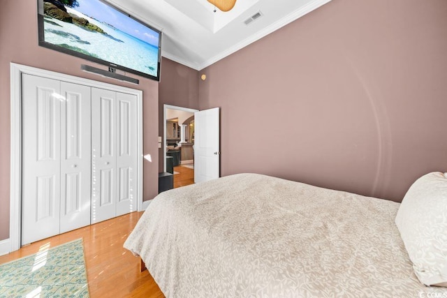 304 76th Ave N Unit D, Myrtle Beach, SC 29572 - bedroom featuring light wood finished floors, crown molding, a high ceiling, and a closet