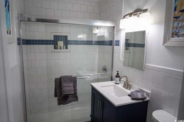 309 21st Ave N, North Myrtle Beach, SC 29582 - bathroom with toilet, vanity, and tile walls