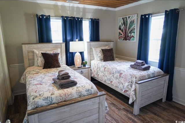 309 21st Ave N, North Myrtle Beach, SC 29582 - bedroom featuring crown molding, multiple windows, and dark wood finished floors