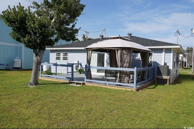 309 21st Ave N, North Myrtle Beach, SC 29582 - rear view of house featuring a gazebo, a lawn, a wooden deck, and central air condition unit
