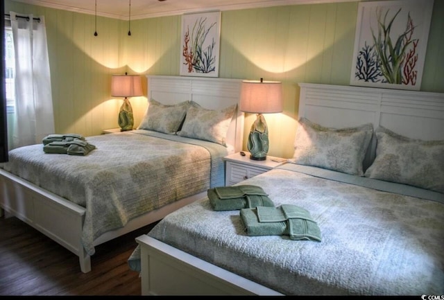 bedroom featuring ornamental molding and dark hardwood / wood-style flooring