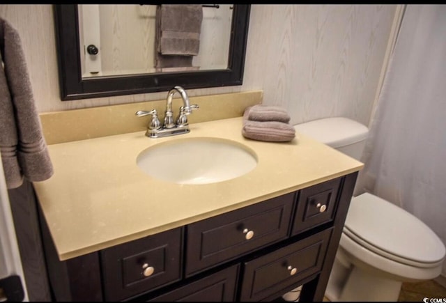 bathroom featuring vanity and toilet