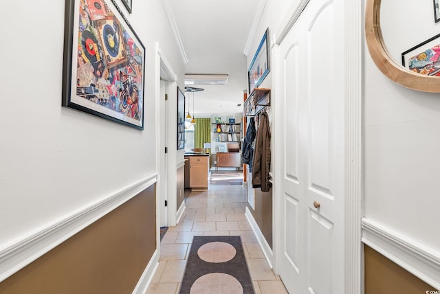 hall featuring a textured ceiling and light tile patterned floors