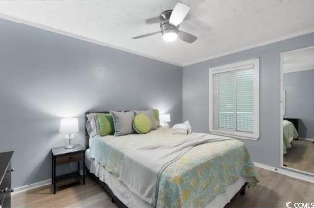 bedroom featuring wood-type flooring and ceiling fan