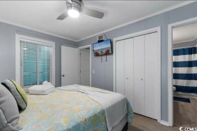 bedroom with crown molding, wood-type flooring, a closet, and ceiling fan