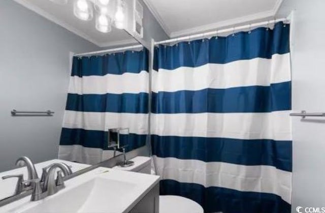 bathroom with vanity, curtained shower, ornamental molding, and toilet