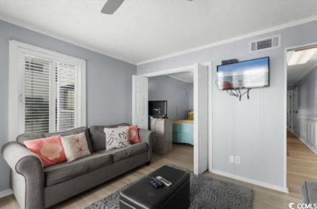 living room with ceiling fan and hardwood / wood-style floors