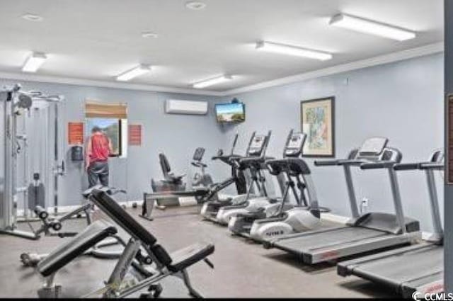 workout area featuring crown molding and a wall unit AC