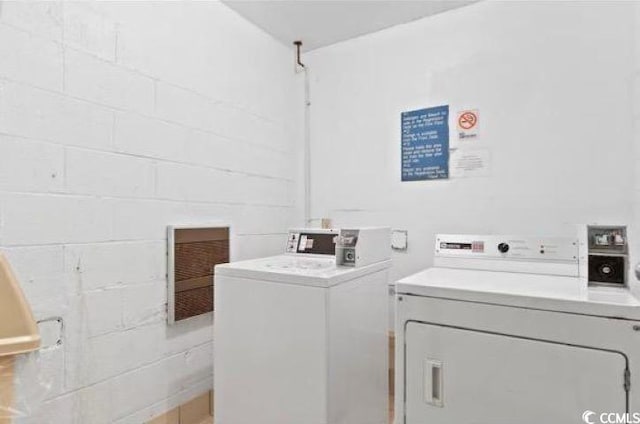 clothes washing area featuring washer and dryer