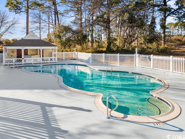 view of swimming pool with a patio area and an outdoor structure