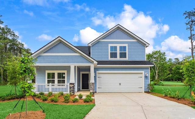9746 Indigo Creek Blvd, Murrells Inlet, SC 29576 - craftsman-style house with a front lawn, concrete driveway, an attached garage, and covered porch