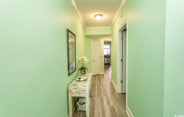 hall featuring light hardwood / wood-style flooring and ornamental molding