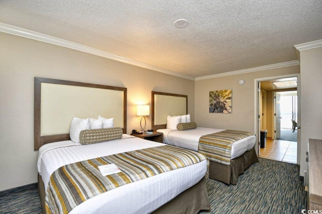 bedroom featuring a textured ceiling, carpet flooring, and crown molding