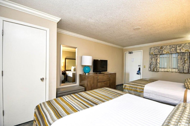 bedroom featuring ornamental molding and a textured ceiling