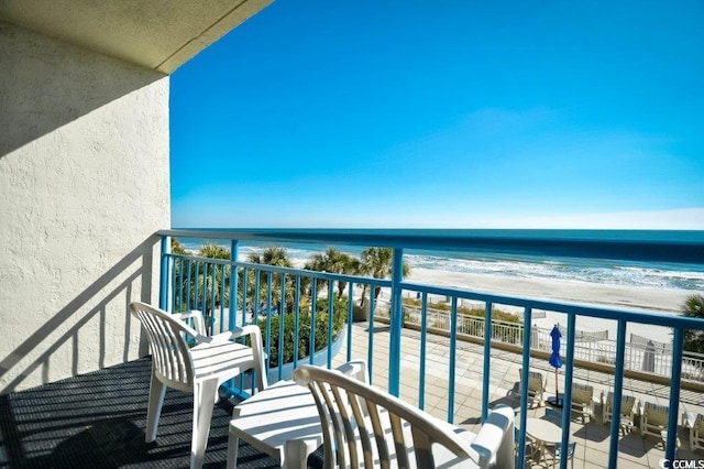 balcony featuring a water view and a view of the beach