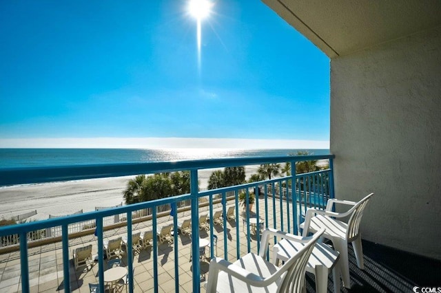 balcony with a water view and a beach view