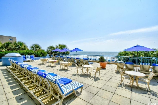 view of patio with a water view