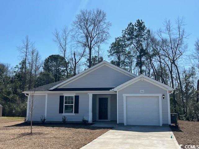 ranch-style home with a garage, concrete driveway, and central AC unit