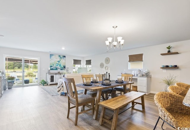 dining room featuring an inviting chandelier and light hardwood / wood-style flooring