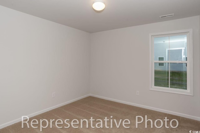 unfurnished room featuring carpet