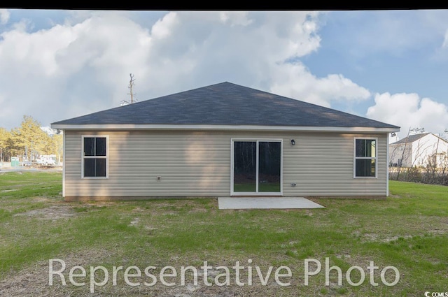 back of property with a patio and a yard