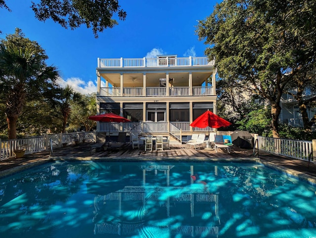 view of swimming pool featuring ceiling fan and a patio area