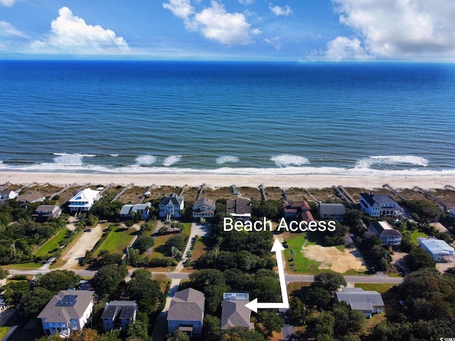 birds eye view of property featuring a beach view and a water view