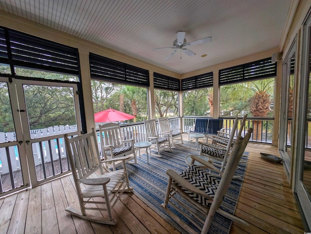 sunroom / solarium featuring ceiling fan