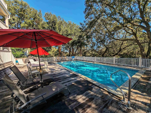 view of swimming pool with a deck