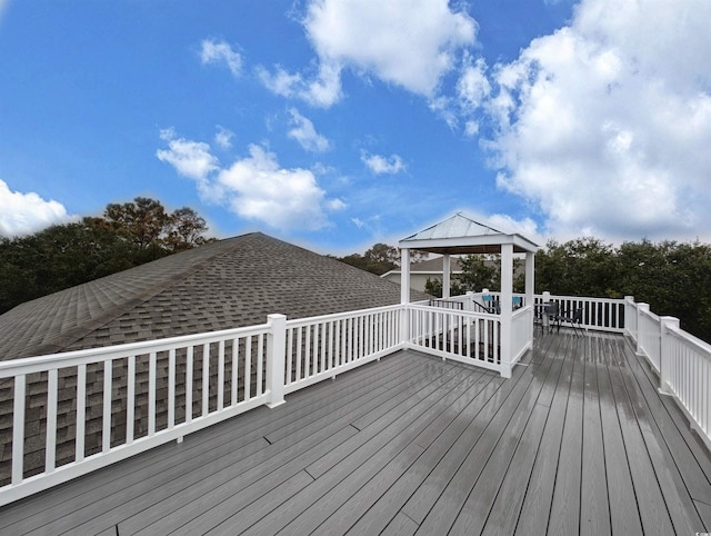 wooden terrace featuring a gazebo