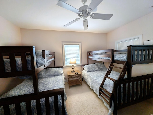 bedroom with light carpet and ceiling fan