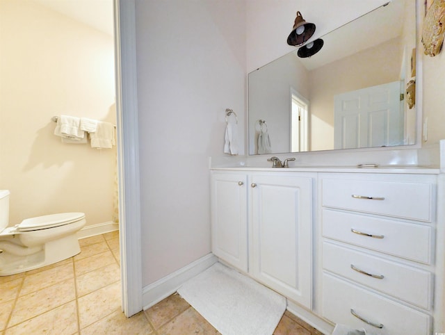 bathroom featuring tile patterned flooring, vanity, and toilet