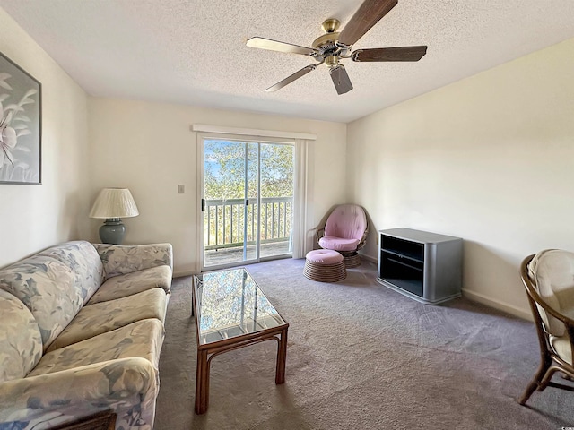 carpeted living room with ceiling fan and a textured ceiling