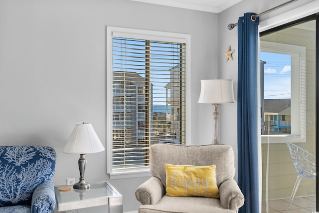 sitting room featuring tile patterned flooring, plenty of natural light, and ornamental molding