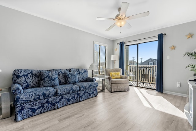 living room featuring ceiling fan, light hardwood / wood-style floors, and ornamental molding