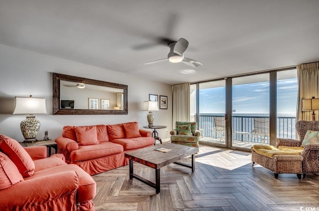 living room with light parquet flooring, a water view, and ceiling fan