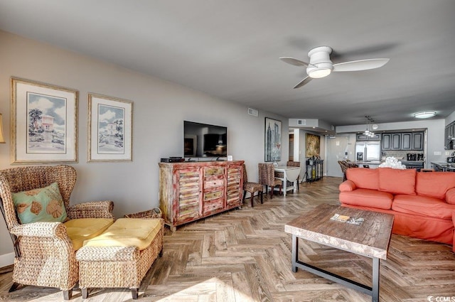 living room featuring ceiling fan and light parquet floors