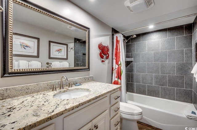 full bathroom featuring vanity, toilet, and shower / bath combination with curtain