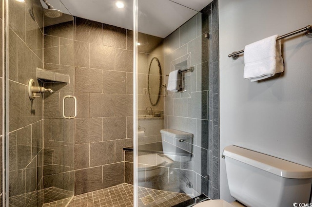 bathroom with an enclosed shower and toilet