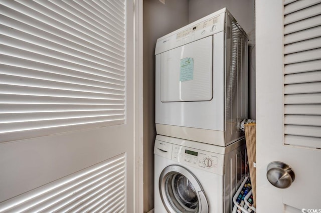 clothes washing area with stacked washer / drying machine