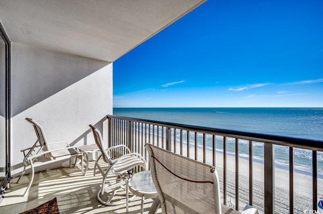 balcony featuring a beach view and a water view