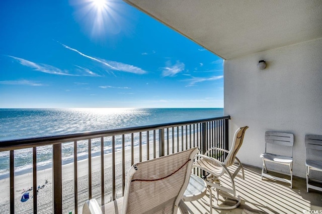 balcony with a beach view and a water view