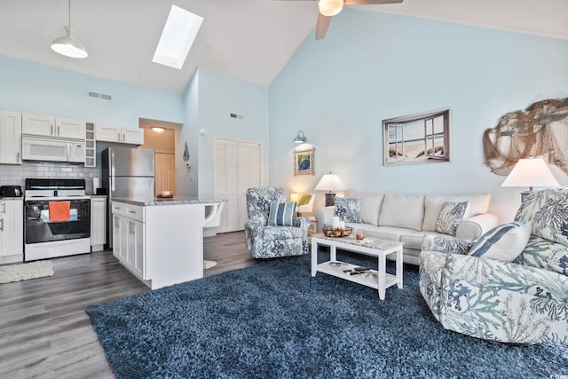 living room with ceiling fan, high vaulted ceiling, and dark wood-type flooring