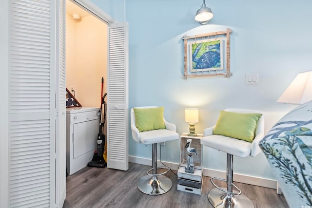 sitting room featuring washer / clothes dryer and dark hardwood / wood-style flooring