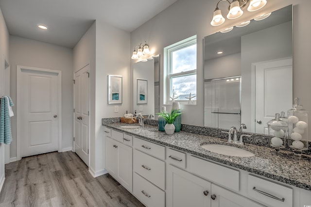 bathroom featuring vanity, wood-type flooring, and walk in shower