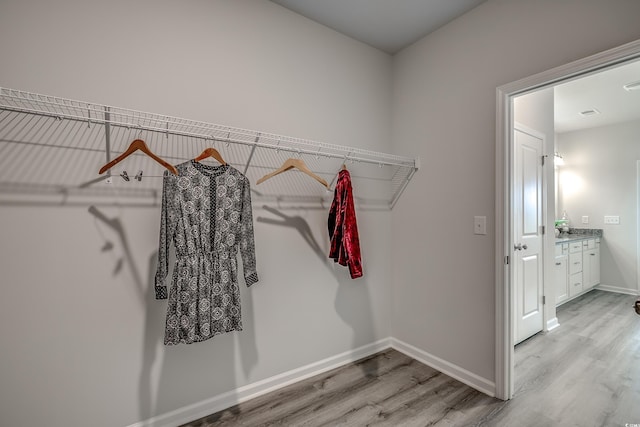 walk in closet featuring light hardwood / wood-style flooring