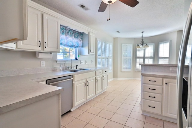 kitchen with dishwasher, pendant lighting, a wealth of natural light, sink, and white cabinetry